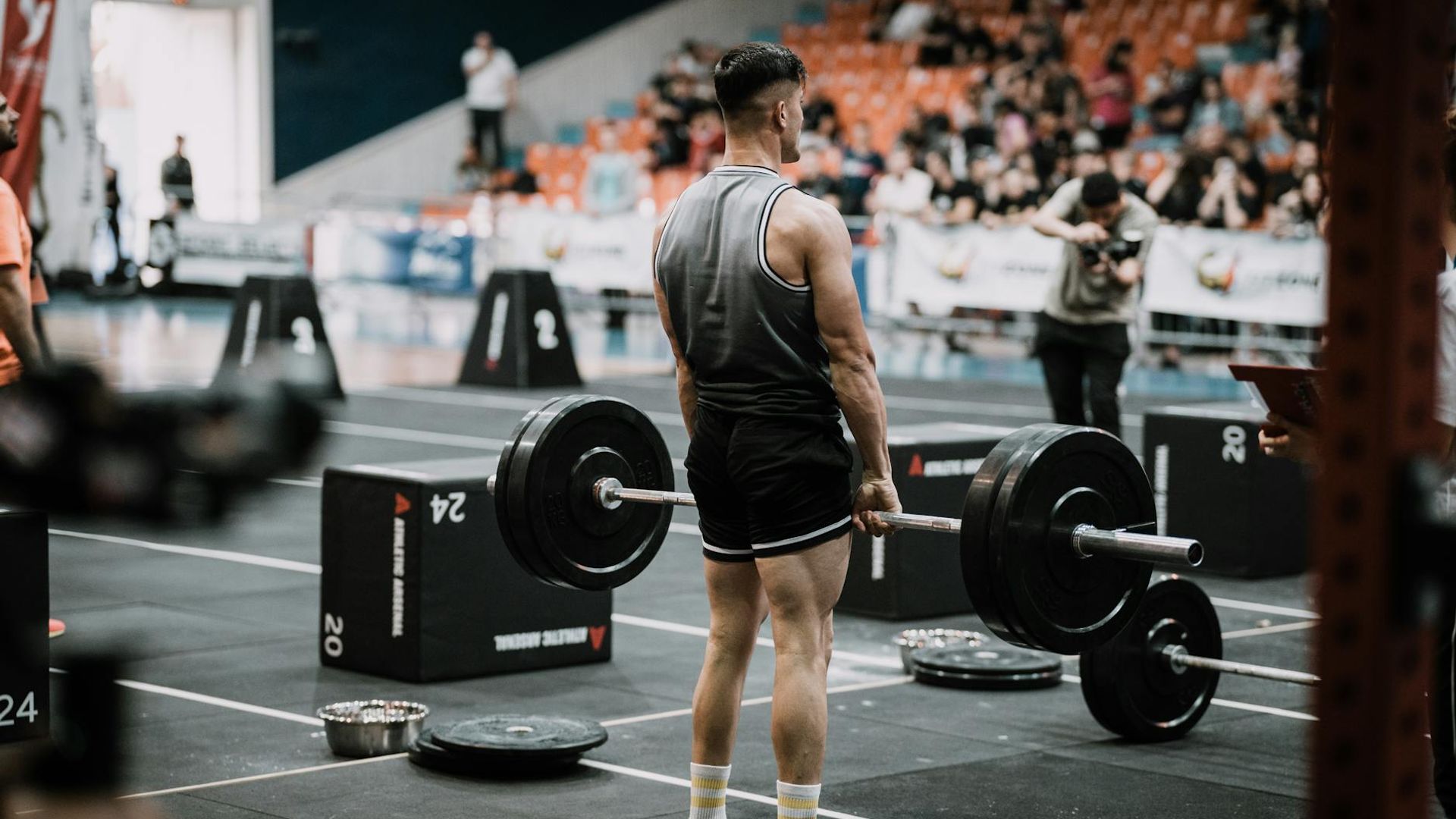 Athletic man performing heavy lifting in a moody dark atmosphere