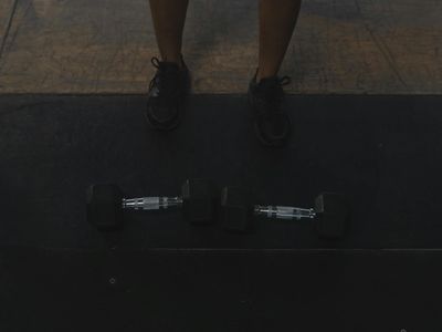 Athletic shoes on a dark gym floor surface