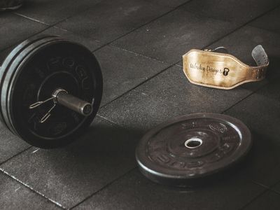 Iron weights on a dark textured rubber floor