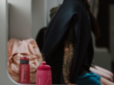 Water bottle and towel in a dark training room